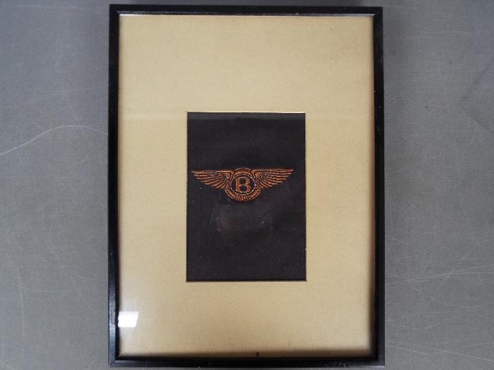 A framed leather Bentley car sign
