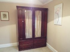 A twin wardrobe having glazed doors and four lower drawers,