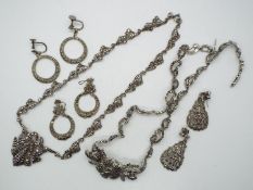 A necklace and pair of drop earring stamped 'silver' and a further white metal necklace and two