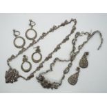 A necklace and pair of drop earring stamped 'silver' and a further white metal necklace and two