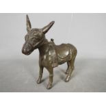 A vintage, cast iron, money bank in the form of a donkey, approximately 12 cm (h).