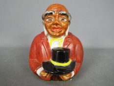 A vintage, American, ceramic money bank in the form of a bust of 'Uncle Mose',