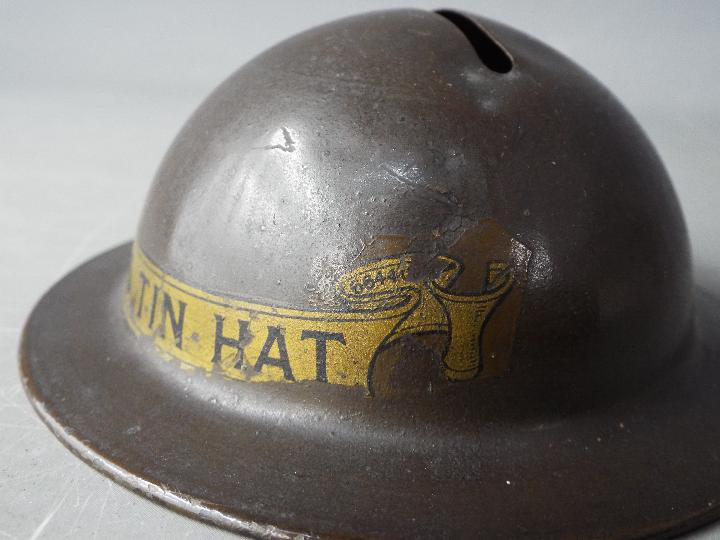 A World War One period novelty, tin money bank in the form of a helmet, titled 'Tommy's Tin Hat' 4. - Image 4 of 6