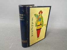 A Chad Valley novelty tinplate money box in the form of a book,