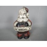 A vintage, cast iron money bank depicting Father Christmas / Santa Claus,