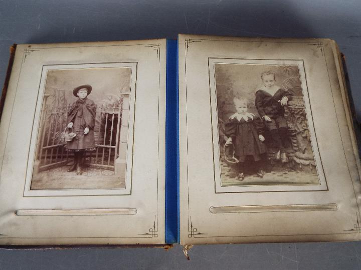 A Victorian, leather bound photograph album with metal clasp, containing photographs. - Image 8 of 10