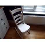 A white painted rocking chair.