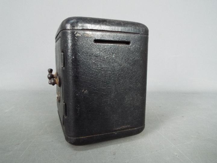 A vintage, novelty money bank in the form of a bank safe, approximately 11 cm (h). - Image 3 of 6