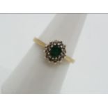 A 9ct gold emerald and diamond cluster ring, size N, approximately 2.4 grams all in.