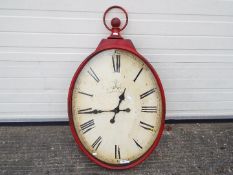 A large, decorative wall clock, approximately 95 cm x 56 cm.
