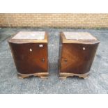 A pair of marble topped bedside cabinets, approximately 55 cm x 45 cm x 38 cm.