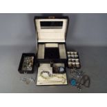 A good quality jewellery box containing a collection of costume jewellery to include a large