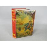 A Chad Valley novelty tinplate money box in the form of a book,