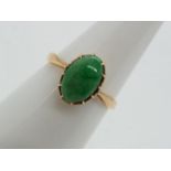 18 ct gold - a 18 ct gold ring set with jade oval stone, size N, approximate weight 2.