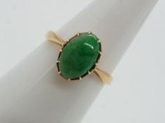 18 ct gold - a 18 ct gold ring set with jade oval stone, size N, approximate weight 2.