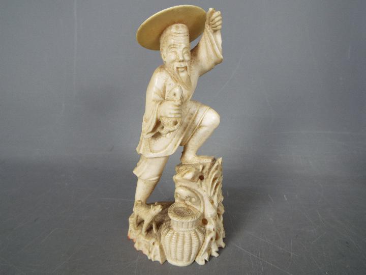 Two early 20th century ivory figurines comprising a fisherman and a courtesan (hand broken but - Image 2 of 6