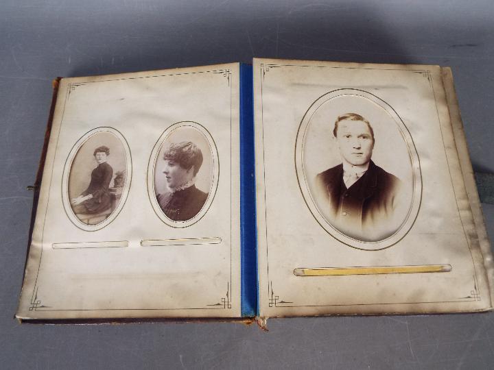 A Victorian, leather bound photograph album with metal clasp, containing photographs. - Image 2 of 10