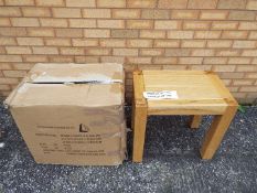 Unused Retail Stock - A nest of three oak tables, largest approximately 55 cm x 60 cm x 40 cm,