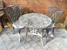 A painted aluminium circular garden table and two chairs [3]