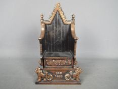 A cast iron John Harper money bank in the form of a throne for the Coronation of Queen Elizabeth II,