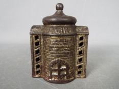 A vintage cast iron money bank of two piece construction, marked 'Bank' to the front,