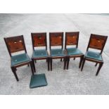 Five dining chairs with carved detailing.