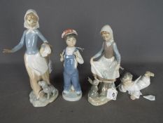 Lladro - Two Lladro figurines including a girl with a rabbit and a boy in dungarees,