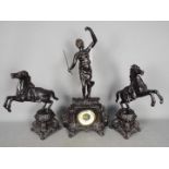 A cast metal mantel clock set, with a matched pair of rearing horses as side pieces, bronzed finish,