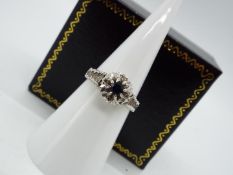 A 9ct, white gold, sapphire and diamond ring, size L, approximately 3 grams all in.