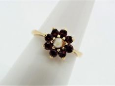 A 9ct gold pearl and garnet cluster ring, size N, approximately 2.1 grams all in.