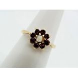 A 9ct gold pearl and garnet cluster ring, size N, approximately 2.1 grams all in.