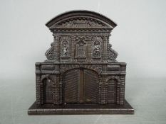 A cast iron, novelty money bank of architectural form,