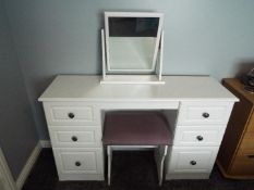 A modern white bedroom suite comprising a dressing table 79 cm x 128 cm x 40 cm with swing mirror