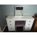 A modern white bedroom suite comprising a dressing table 79 cm x 128 cm x 40 cm with swing mirror