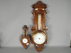 A highly carved oak cased banjo aneroid barometer, approx.