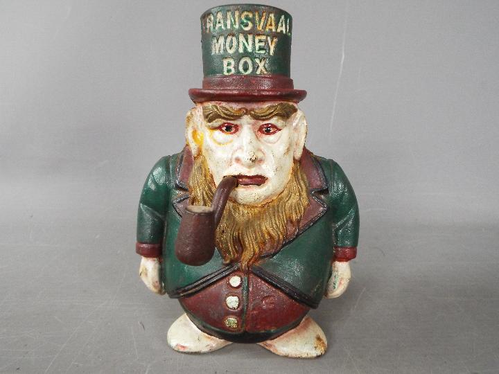 A cast iron 'Transvaal Money Box' in the form of a caricatured President Kruger,