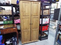 A twin door wardrobe measuring approximately 188 cm x 86 cm x 54 cm.