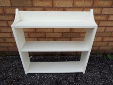 A small freestanding bookcase, approximately 70 cm x 70 cm x 17 cm.