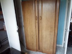 An Art Deco twin wardrobe with fitted interior to one side,