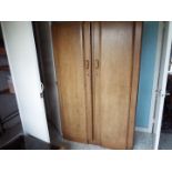 An Art Deco twin wardrobe with fitted interior to one side,