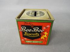 An unusual Bee Bee Biscuits tin money bank,