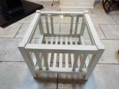 A glass topped occasional table measuring approximately 50 cm x 60 cm x 60 cm