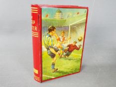 A Chad Valley novelty tinplate money box in the form of a book,