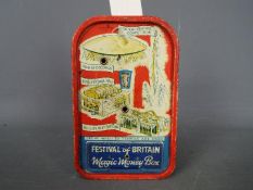 A 1951 Festival of Britain tinplate 'Magic Money Box' printed with The Shot Tower and other
