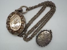 A hallmarked silver photograph locket with engraved bird decoration,