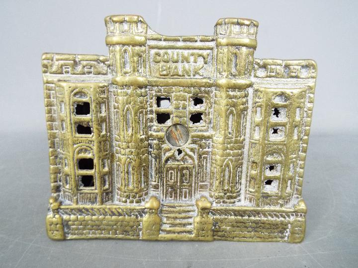 A cast brass 'County Bank' money bank, approximately 10.5 cm (h). - Image 3 of 4