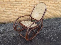 Large bentwood rocking chair with cane seat and back.