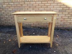 A modern, light oak console table, approximately 75 cm x 79 cm x 30 cm.