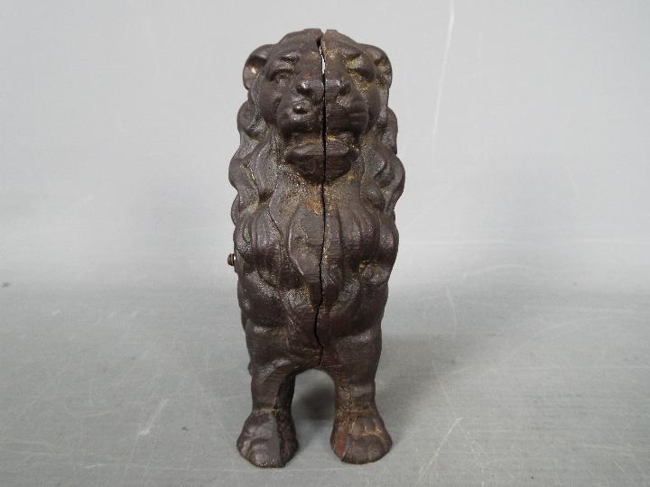 A cast iron money bank in the form of a seated male lion, - Image 2 of 5