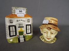 Two ceramic money banks one in the form of a bust of a young boy, the other in the form of a bank,